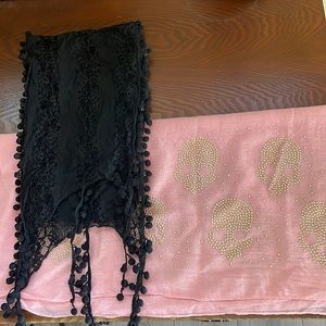 Two scarves. One thin black lace one large pink with skulls.